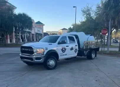 A white truck with a dog on the back of it.